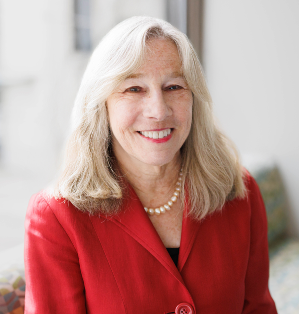 Leanne Berge with blond shoulder length hair wearing red blazer